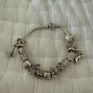 Pandora bracelet with 13 charms and 2 safety clips